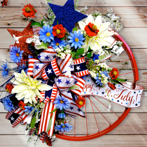 Red White and Blue Bicycle wheel with floral and glitter fireworks, finished with a bow